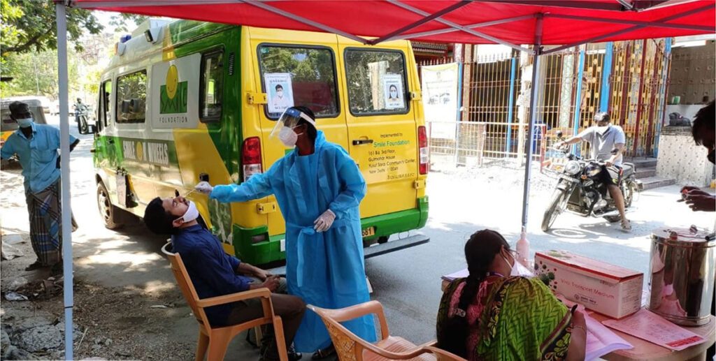 An RT-PCR test for the coronavirus is being carried out by a Smile on Wheels volunteer.