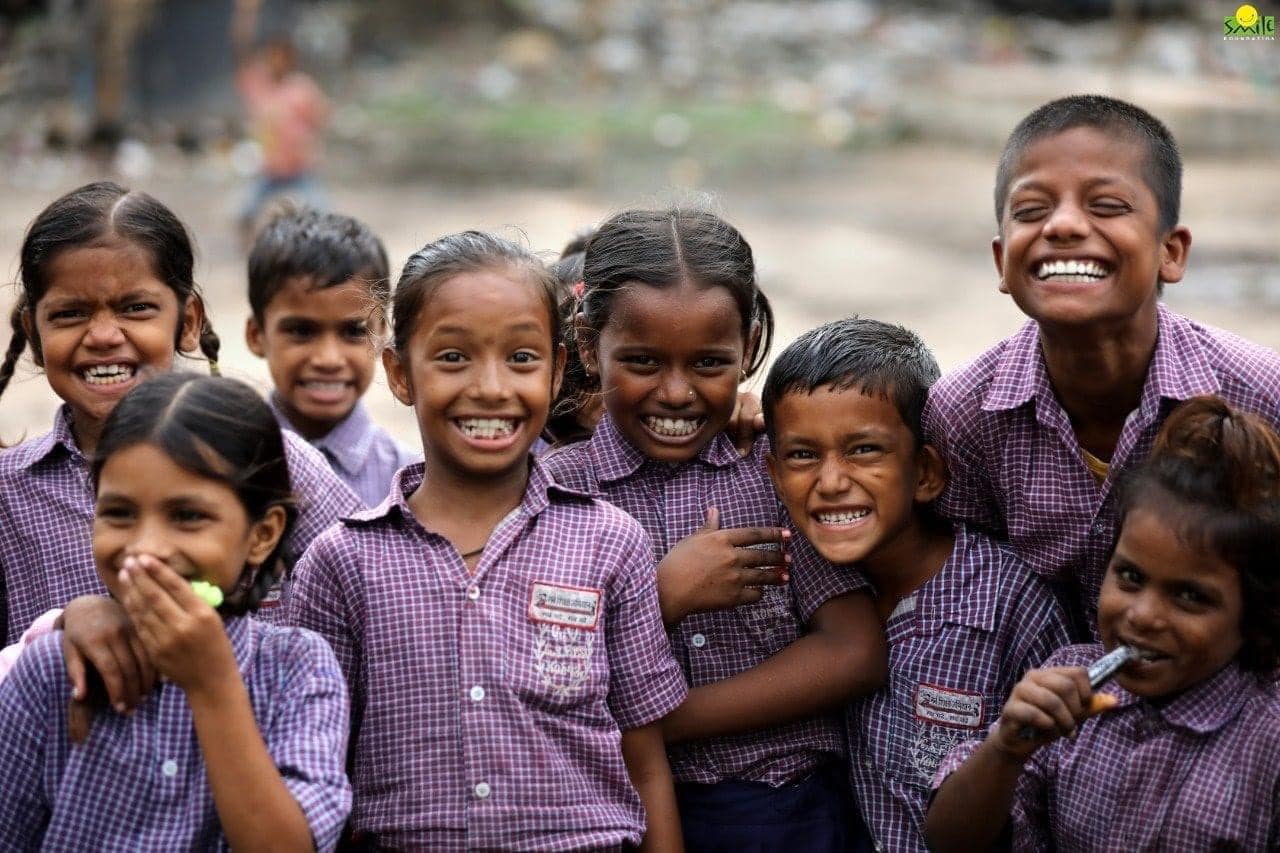 Kids at a Mission Education centre with the biggest smiles on their faces