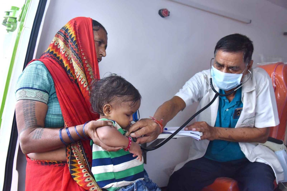 Doctor examining child in ambulance: National Doctor's Day